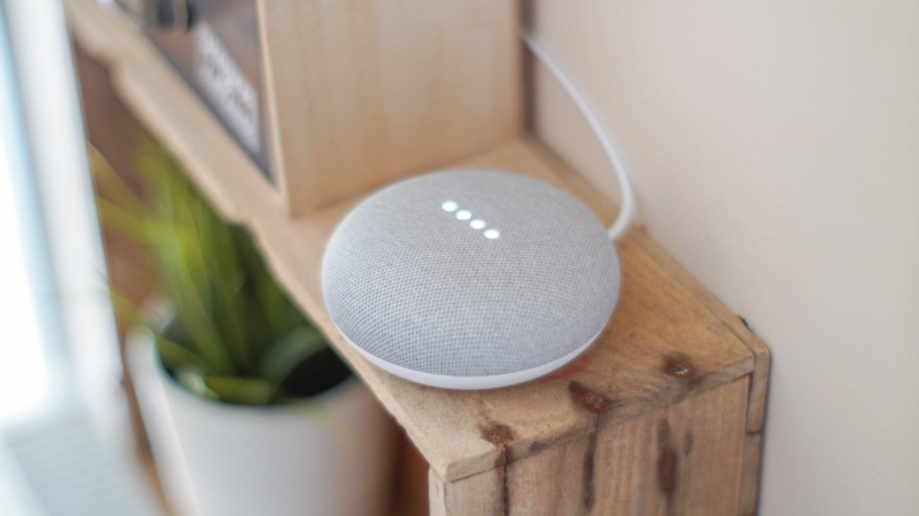 round grey speaker on brown board