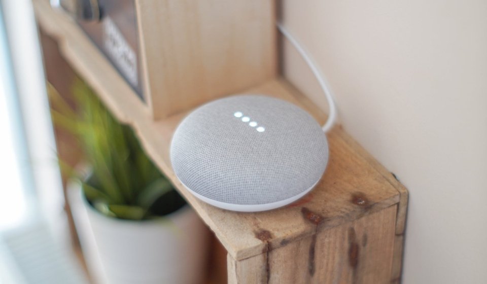 round grey speaker on brown board